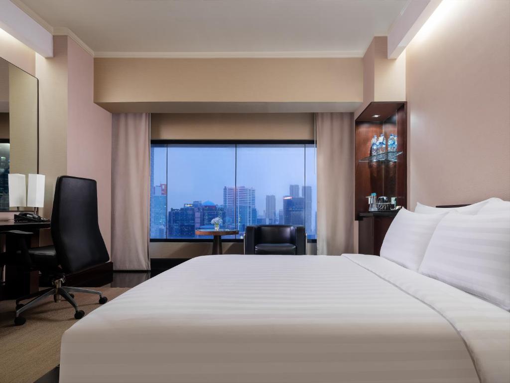 Ένα ή περισσότερα κρεβάτια σε δωμάτιο στο Manhattan Hotel Jakarta