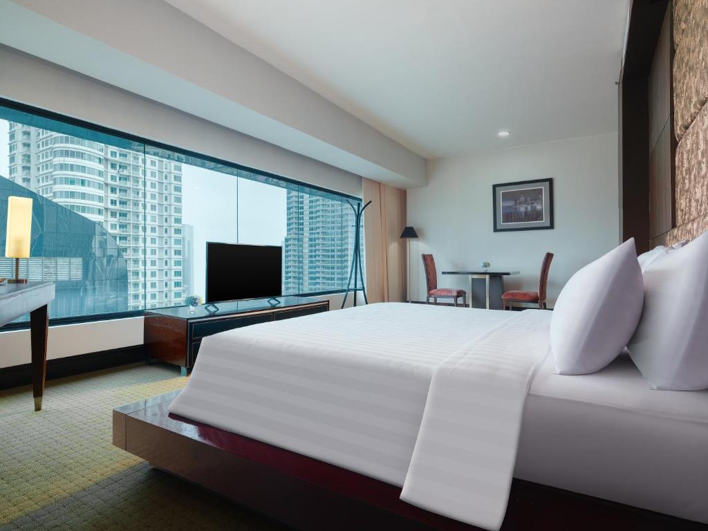 Ένα ή περισσότερα κρεβάτια σε δωμάτιο στο Manhattan Hotel Jakarta