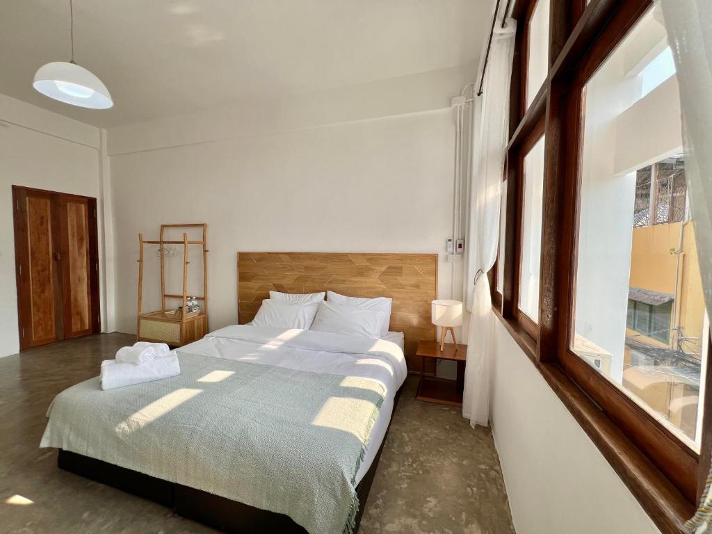 a bedroom with a large bed and a window at Sabay Home in Bangkok