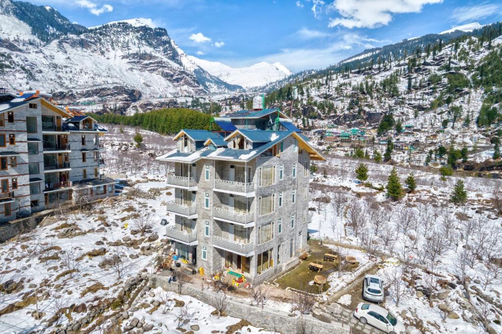 an aerial view of a building in the snow at La Aero Resort Home in Snow Mountains in Manāli