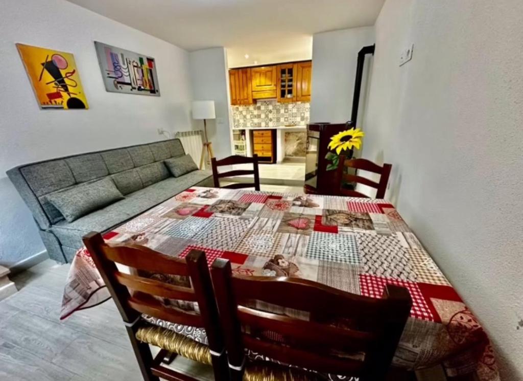 a living room with a table and a couch at CASTAGNA BIANCA - Tuscan ToBe srl in Santa Fiora