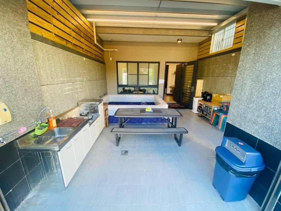 a room with a bed and a sink in a room at Pengjia Villa in Hengchun South Gate