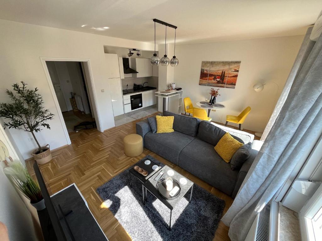 an overhead view of a living room with a couch at Sweet yellow in Zagreb