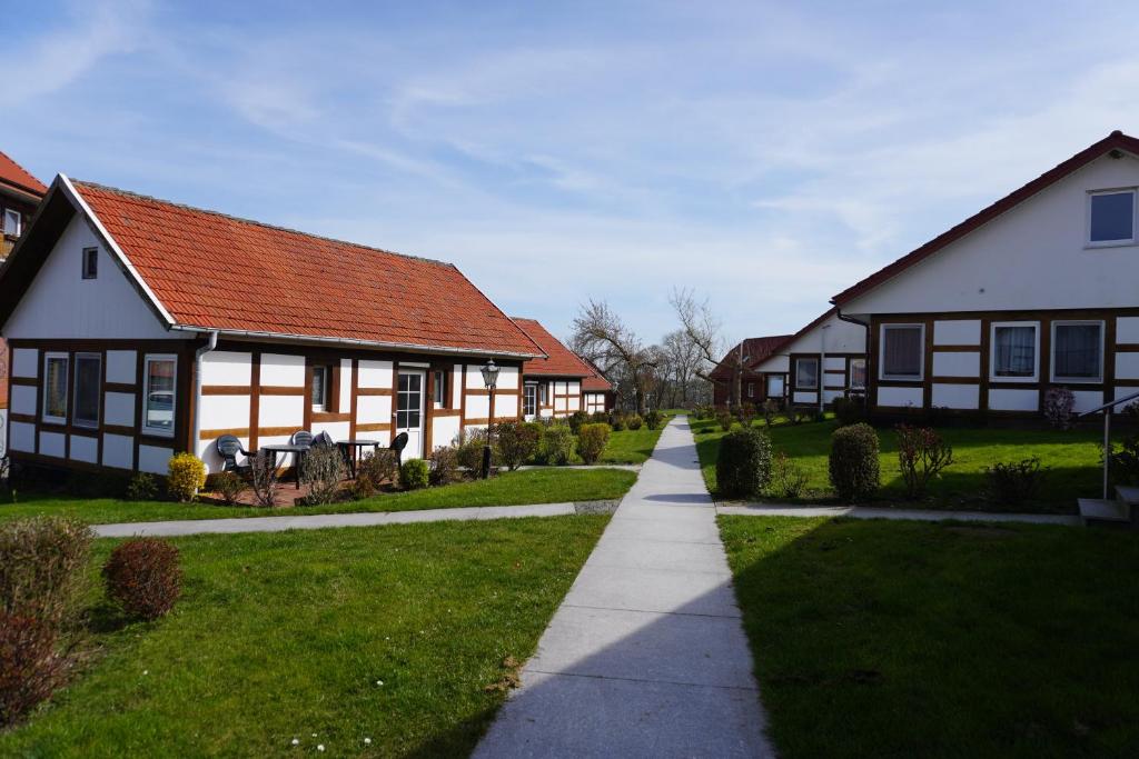 a row of houses with a sidewalk in front at Alcor Hotel Feriendorf an der Ostsee in Wohlenberg