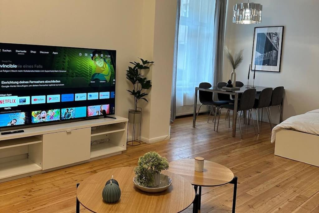 a living room with a large flat screen tv at Modern 2Room Apartment/Neukölln in Berlin