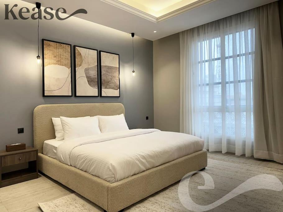 a bedroom with a bed and a large window at Kease Malqa D-12 Royal Touch GZ20 in Riyadh