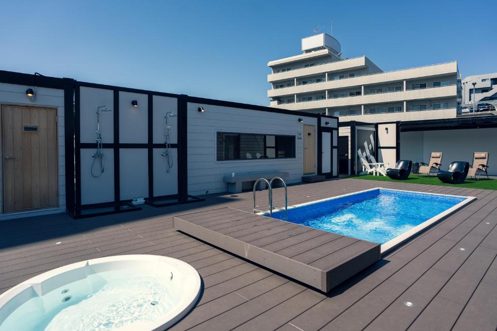 a swimming pool on the deck of a building at HUBHUB新百合ヶ丘 in Shiomidai