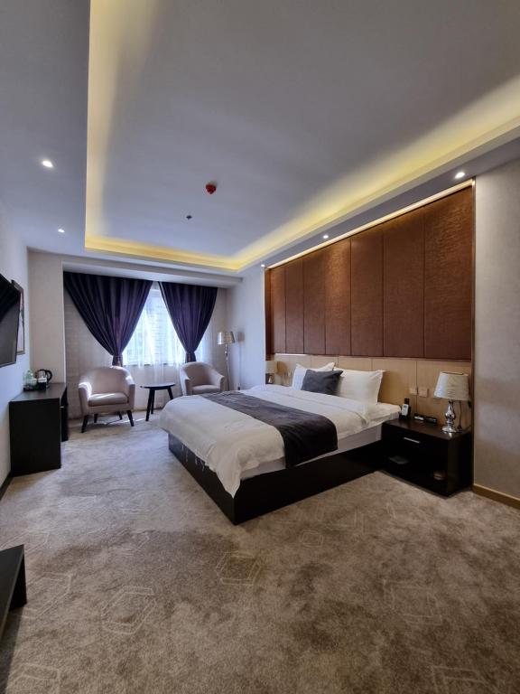 מיטה או מיטות בחדר ב-Friendship HOTEL