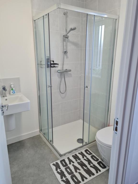 a bathroom with a shower with a toilet and a sink at Supreme Room in Thornaby on Tees