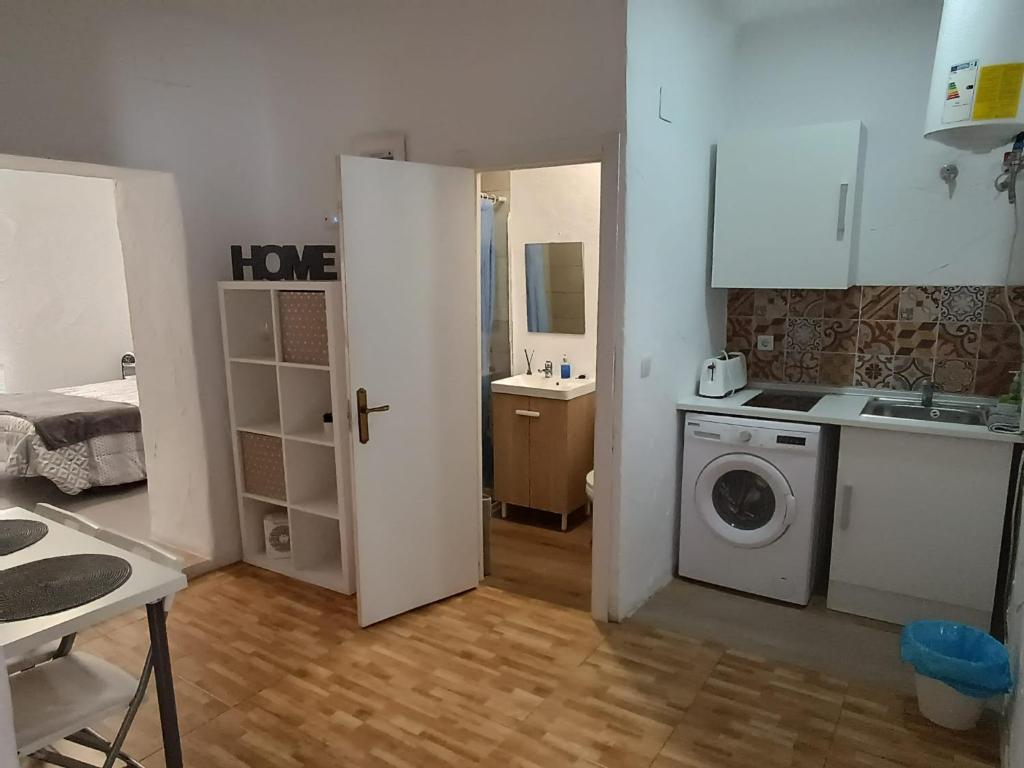 una pequeña cocina con lavadora y secadora en una habitación en Apartamentos La Campana 1, en Jerez de la Frontera