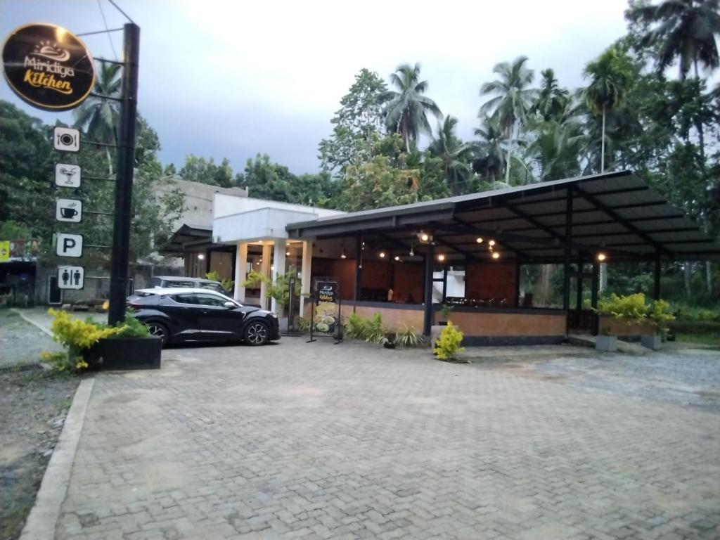 a car parked in front of a building at Miridiya Resort in Yatiyantota