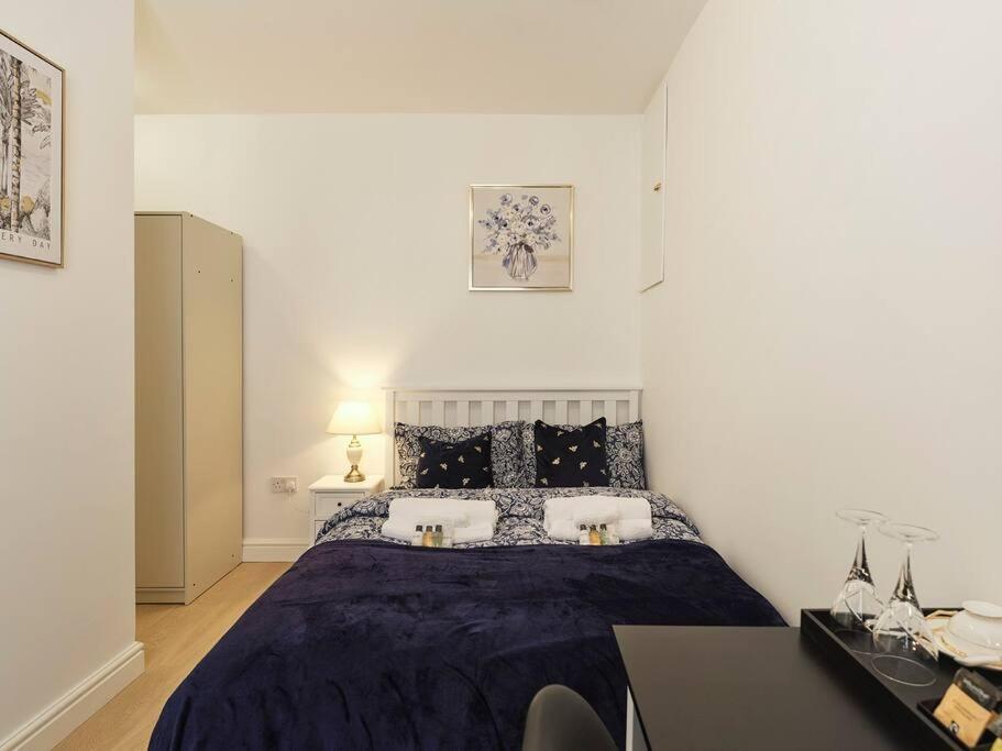 a bedroom with a bed and a desk in it at Rofennie Suite -Luxury ensuite room! in Maidstone