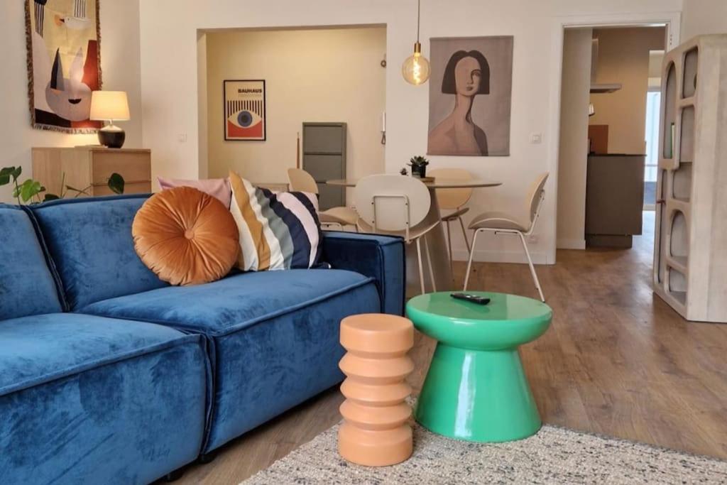 a living room with a blue couch and a table at Gezellig appartement in Vilvoorde in Vilvoorde