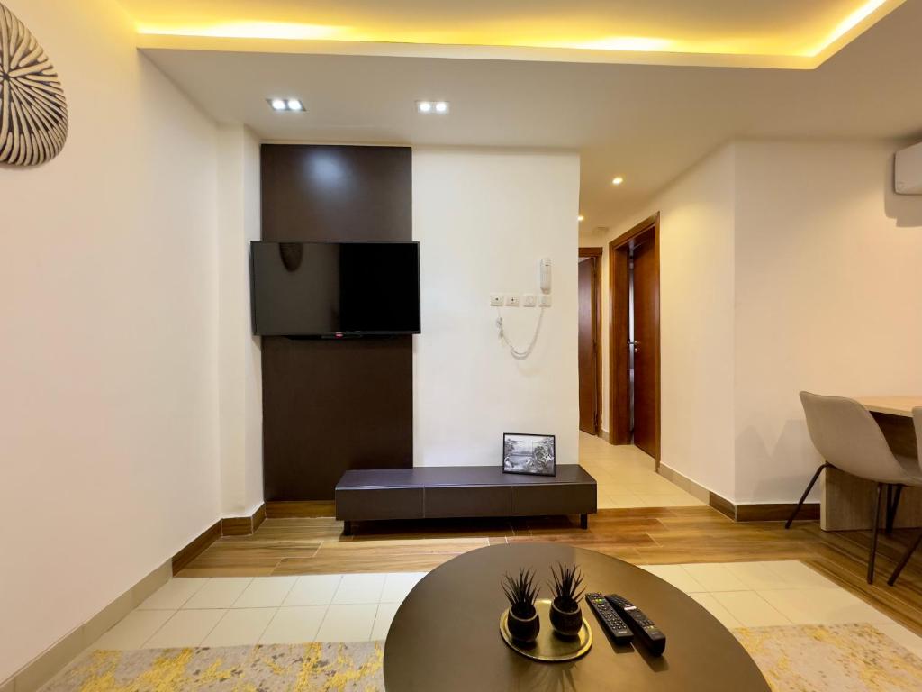 a living room with a table and a couch at Swanky apartment in Douala