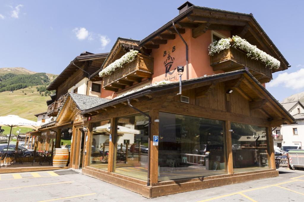 a building with glass windows on the side of it at B&B The King in Livigno