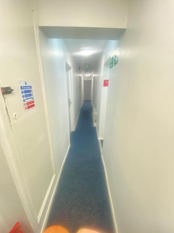 a long hallway with a long blue aisle at Pacific hotel in Clacton-on-Sea