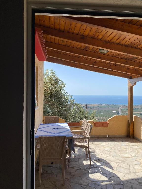 a table and chairs on a patio with a view at Evgoro in Chania