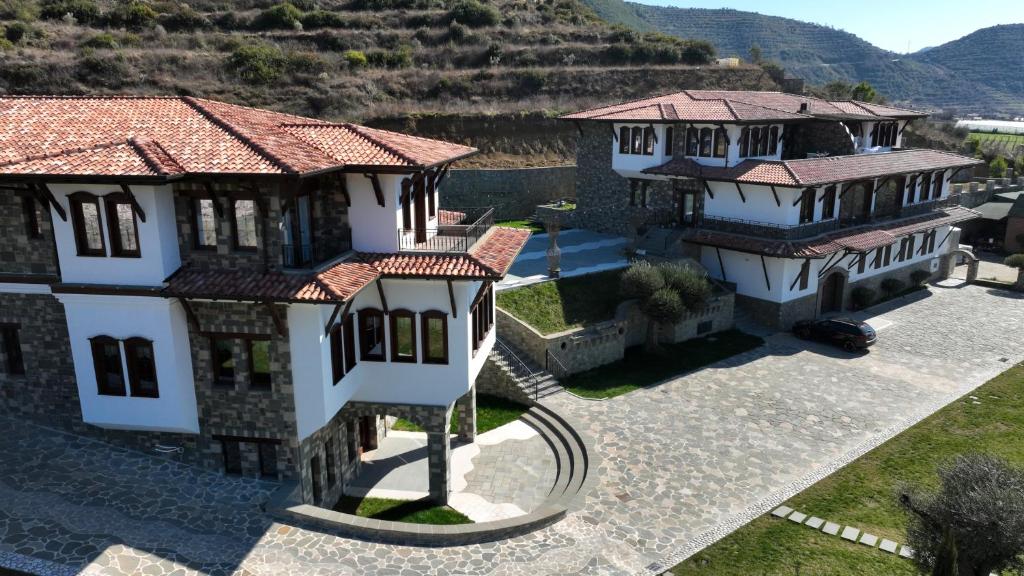 an aerial view of a house with a mountain at Pupa Winery Serene Stay in Berat