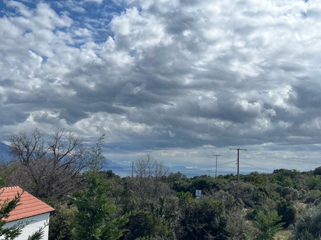 a cloudy sky with trees and a house at Villa SHU in Krimovice