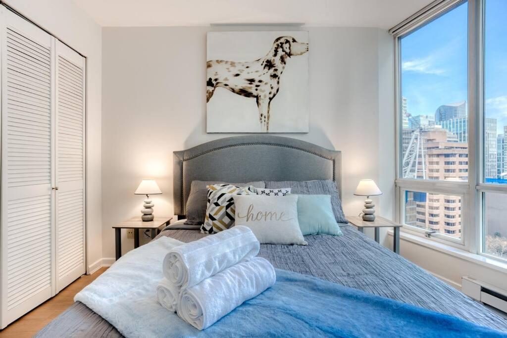 a bedroom with a bed with a dog on the wall at lean & Cozy 1 Bedroom by Convention Center incl. Parking in Vancouver