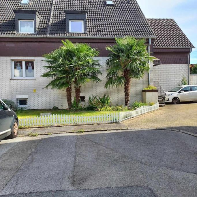 a house with two palm trees in front of it at Zwei-Zimmer-Appartement Essen in Essen