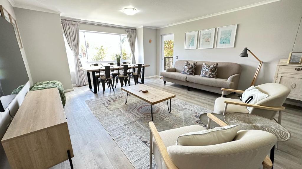 a living room with a couch and a table at Greenpoint Mews 17, Plettenberg Bay in Plettenberg Bay