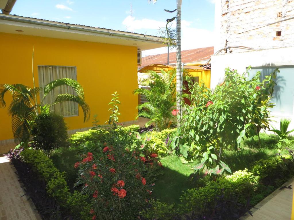 un jardín frente a una casa amarilla en RentvistaVerde, en Tarapoto