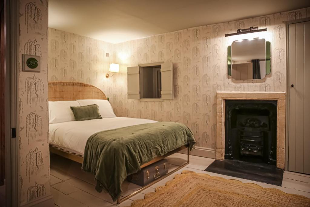 a bedroom with a bed and a fireplace at Daylily Cottage - Two Bedroom Georgian Cottage in Central Bath in Bath