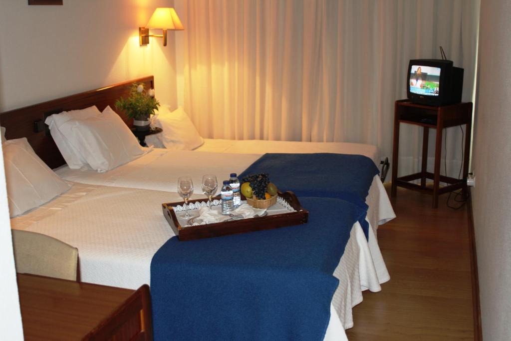 Postel nebo postele na pokoji v ubytování Hotel de Arganil