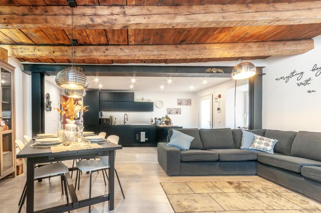 a living room with a couch and a table at Contrada della Fontana Luxury Apartment in Levico Terme