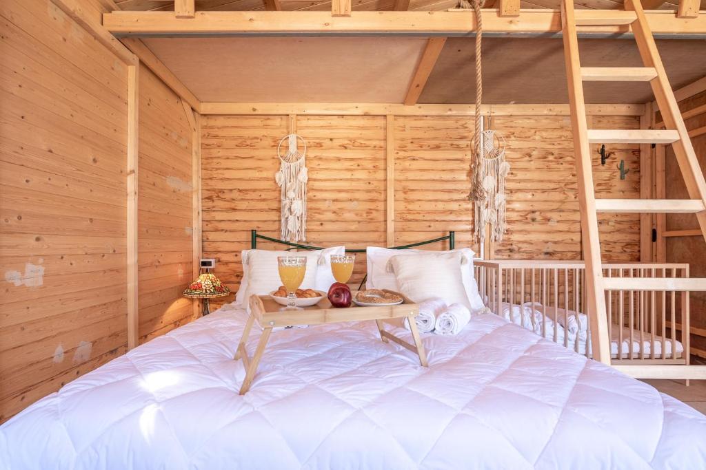 a bed in a room with a table on it at Wooden House Apartments in Kaláthenai
