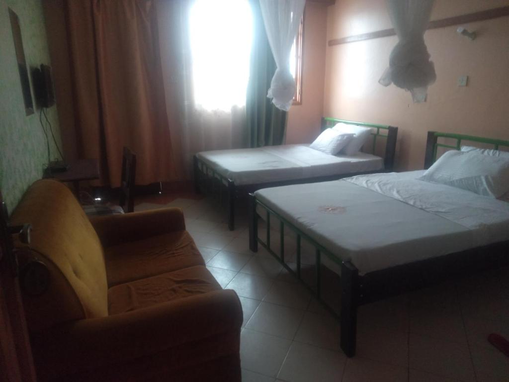 Una cama o camas en una habitación de Riversand Hotel, rooms with lake views,WI FI & balcony