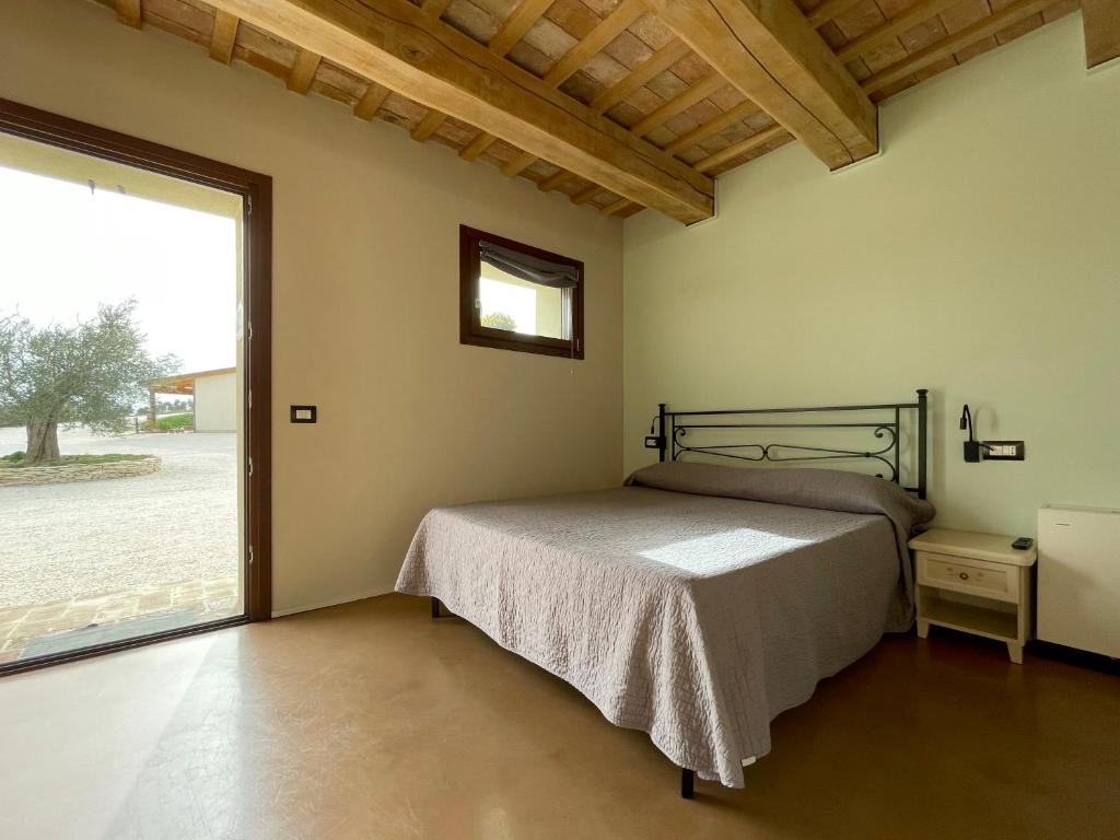 A bed or beds in a room at Casale dei Cinque Colli