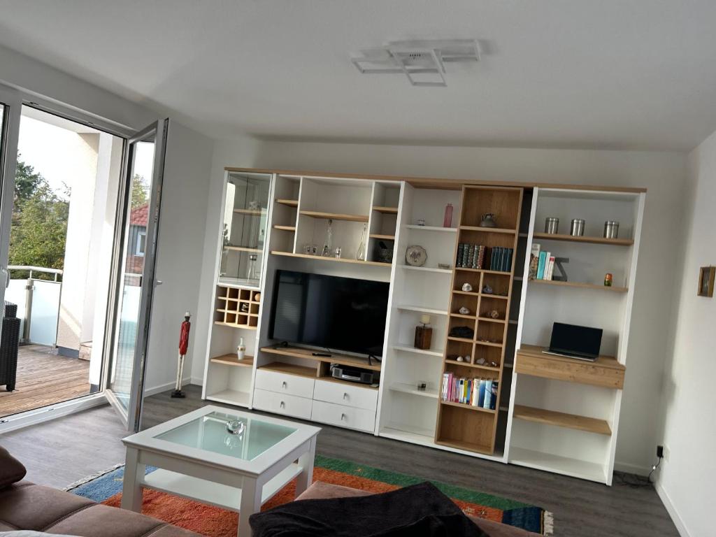 a living room with a large white book shelf at Exklusive Penthouse-Wohnung mit Blick über Marburg in Marburg an der Lahn
