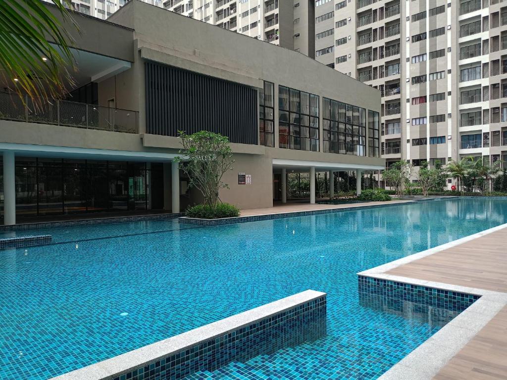 a large swimming pool in front of a building at Homesbyfs Youth City KLIA in Nilai