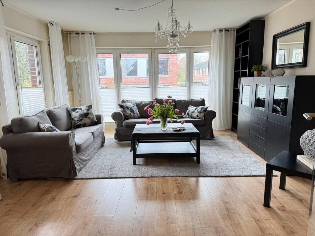 a living room with a couch and a coffee table at Central City Apartment Cloppenburg in Cloppenburg