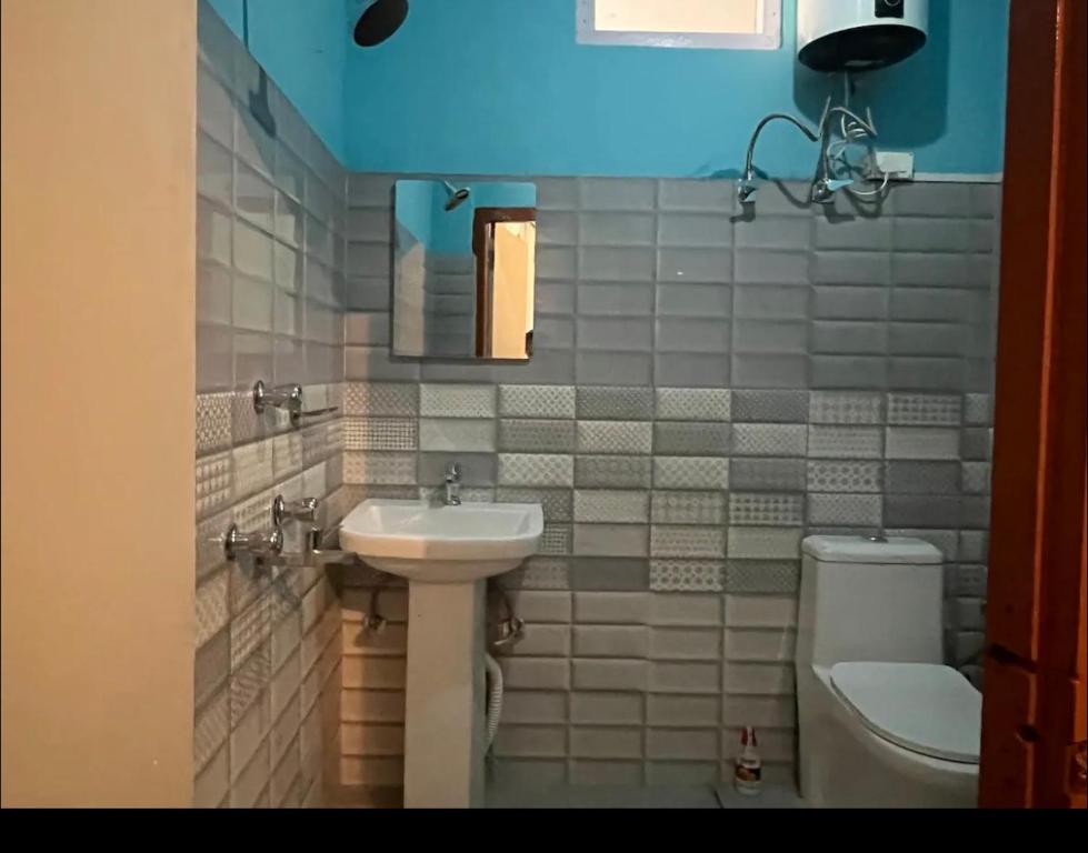 a bathroom with a sink and a toilet at Teesta Inn in Gangtok