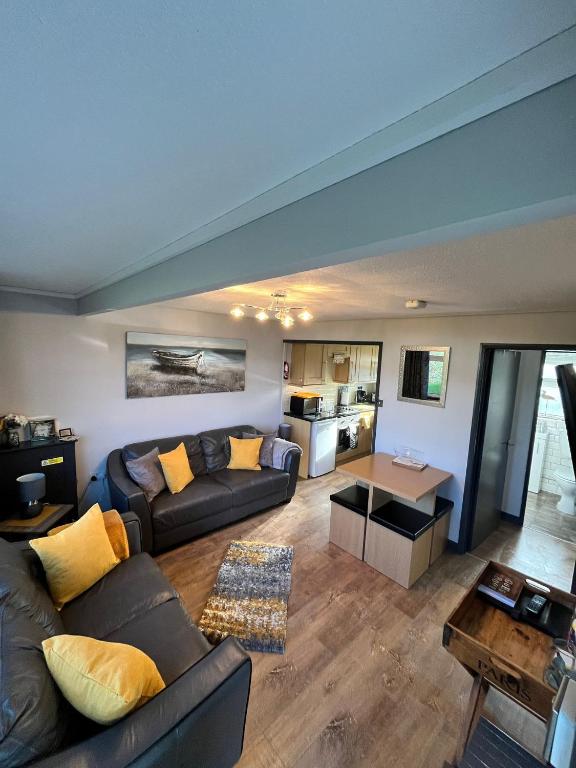 a living room with a couch and a table at 44 Sundowner Hemsby in Great Yarmouth