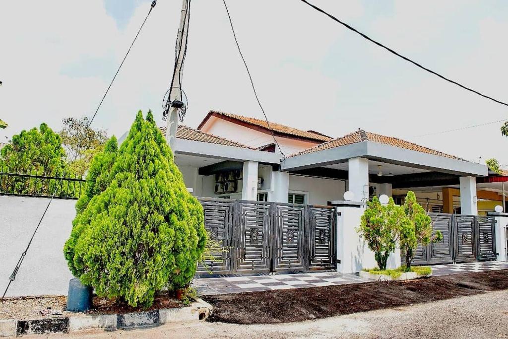 a house with a christmas tree in front of it at De Luma Alma 9 bedroom with 8 bathroom in Bukit Mertajam
