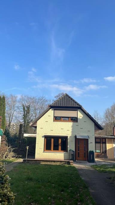 a small white house with a black roof at Sleep Point Bremermann in Bremen