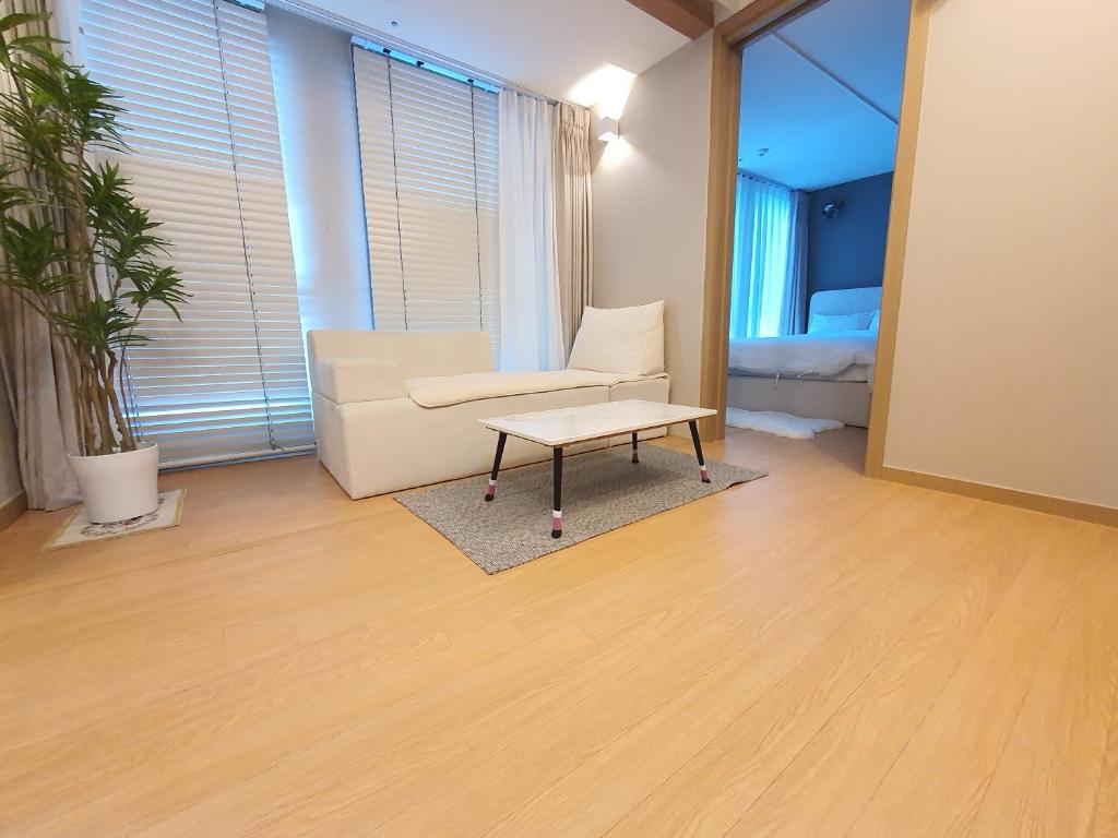 uma sala de estar com um sofá e uma mesa de centro em La Elbon stay in Haewoondae beach em Busan