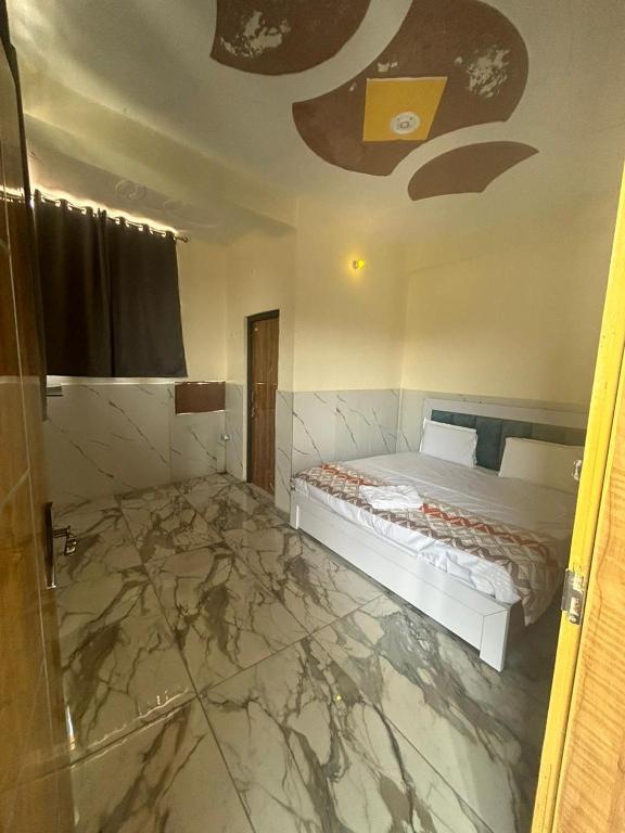 a bedroom with a bed and a marble floor at Moonlight hotel in Greater Noida