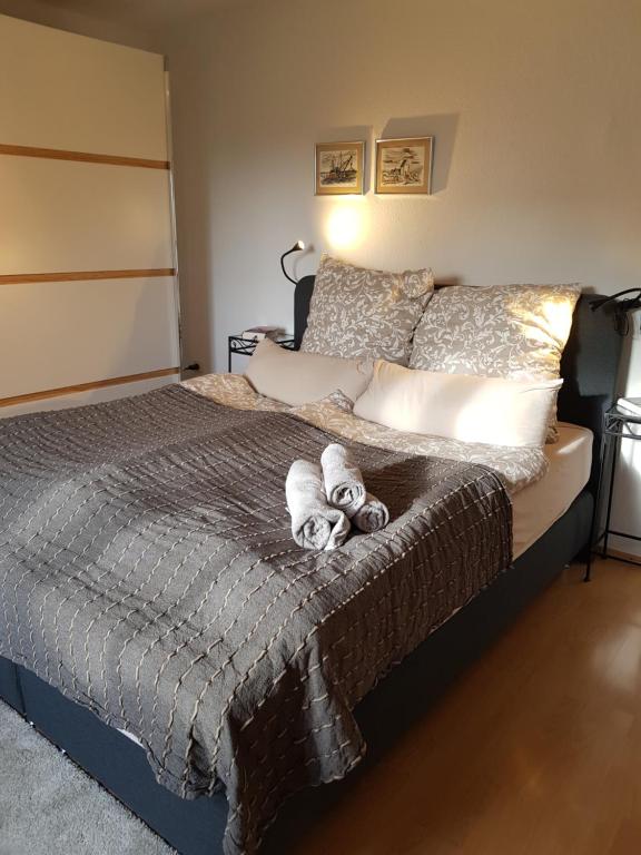a bedroom with a bed with two stuffed animals on it at Ferienwohnung 'dasBRENNERs' in Groß-Umstadt