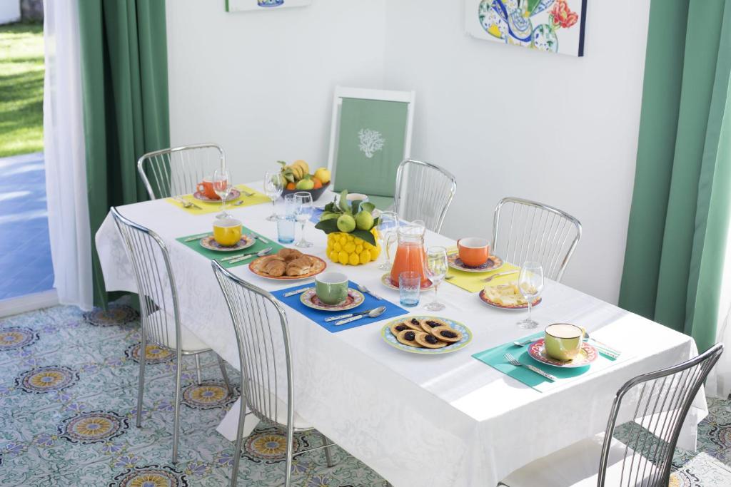 - une table blanche avec des aliments pour le petit-déjeuner dans l'établissement Villa Kalu' with pool for up to 16 People, à Nerano