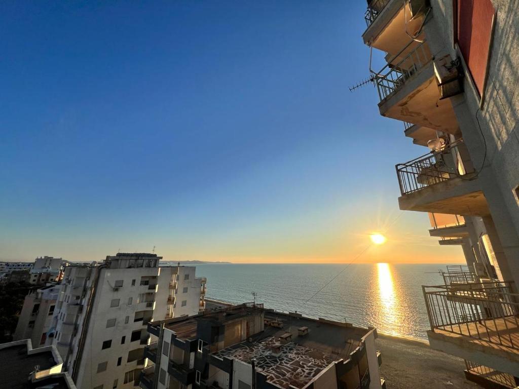 a view of the ocean from between buildings at Beach Home Retreat in Durrës