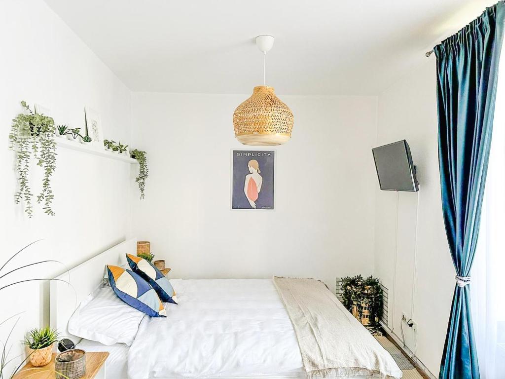a bedroom with a bed with blue curtains at Zen Studio in Braşov