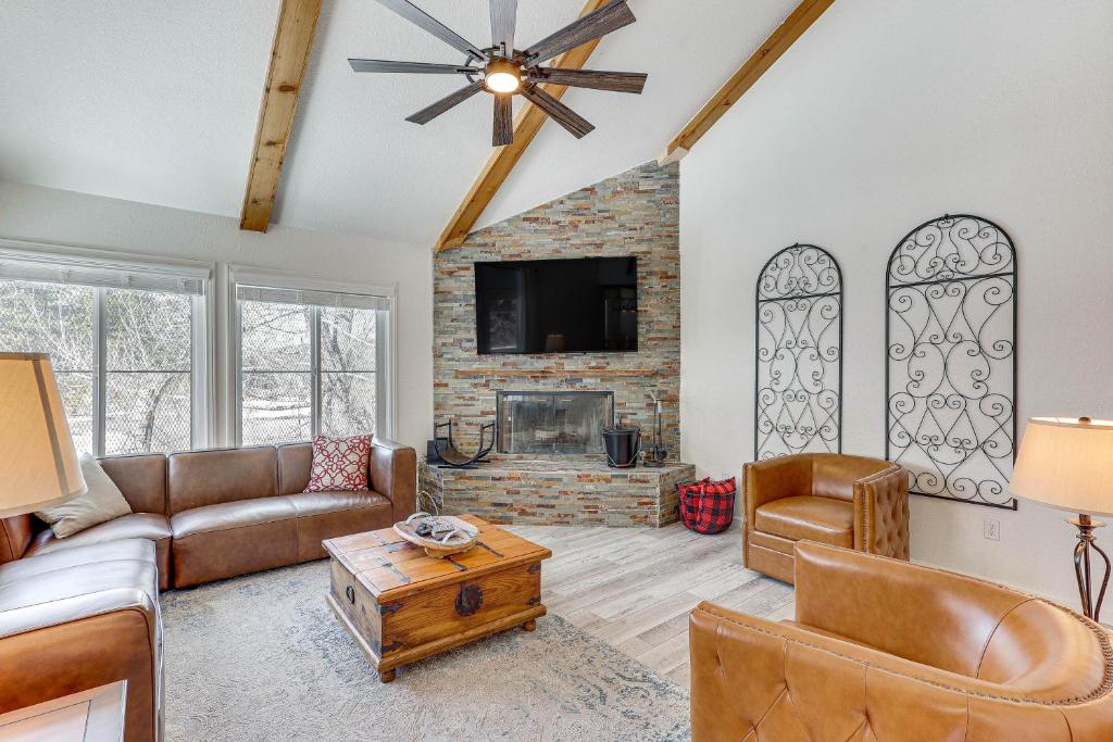 a living room with a couch and a fireplace at Big Bear Lake Condo with Deck, Steps to Ski Lift in Big Bear Lake