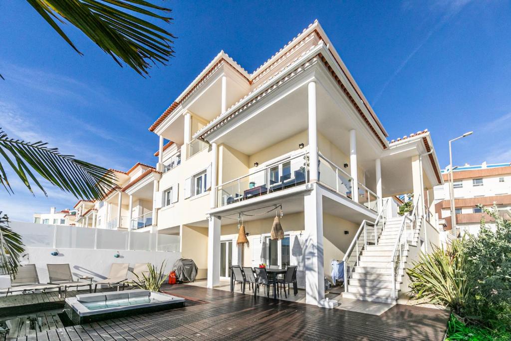 Dieses weiße Haus verfügt über einen Balkon und eine Terrasse. in der Unterkunft Vibing & Liming Ericeira in Ericeira