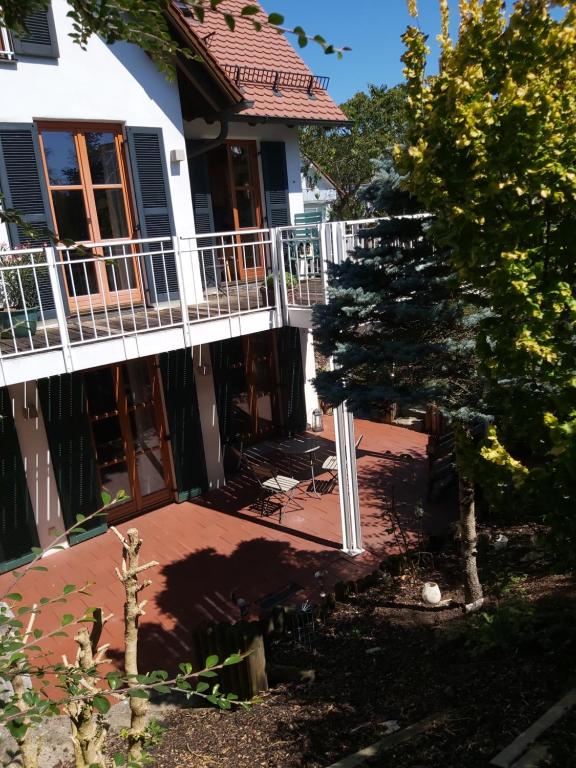 a house with a patio and a tree in front of it at Waldwinkel in Treuchtlingen
