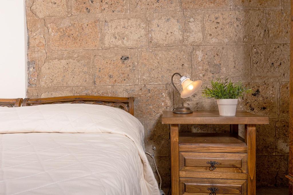 A bed or beds in a room at La Rocca - Palazzo Pallotti